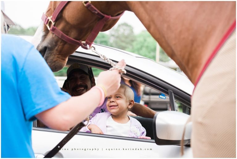biggest smiling little girl finding hope with horsey friends